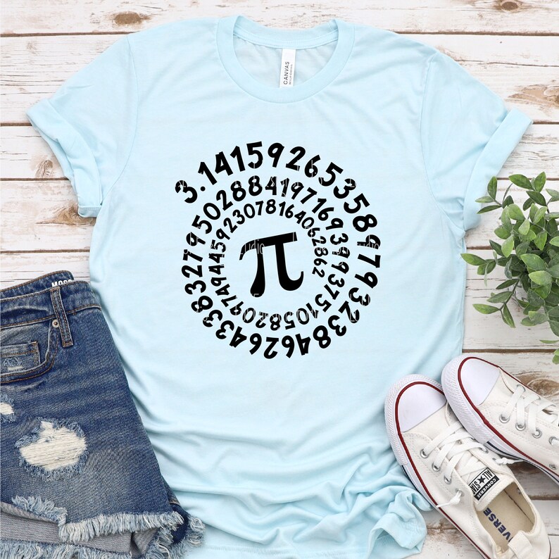 May include: A light blue t-shirt with a black graphic of the mathematical constant pi, surrounded by a circle of numbers. The numbers represent the first digits of pi.