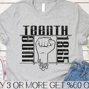 May include: A gray t-shirt with a black graphic design. The graphic features a raised fist with dripping paint and the text "teenth 1865".
