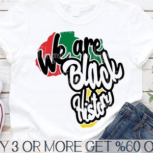 May include: White t-shirt with a graphic design featuring the African continent in red, green, and yellow, with the words "We are Black History" in a bold, stylized font. The shirt is paired with blue jeans.