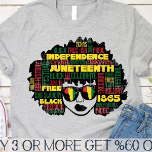May include: A gray t-shirt with a black silhouette of a woman's head with an afro. The afro is filled with text in red, yellow, and green, including "Black Free-ish Pride", "Independence", "Juneteenth", "Celebrate", "Free", "End Slavery", "Black", "Freedom", "Texas", "1865", and "Holiday".