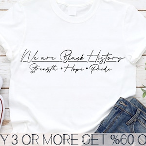 May include: White t-shirt with black text that reads "We are Black History - Strength - Hope - Pride".