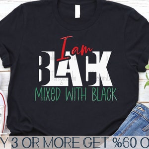 May include: Black t-shirt with white text that reads "I am Black Mixed with Black". The text is in red, white, and green.