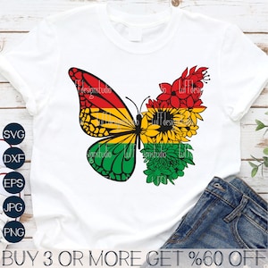 May include: A white t-shirt featuring a black butterfly design. The butterfly's wings are composed of red, yellow, and green flowers. The text "BUY 3 OR MORE GET %60 OFF" is printed at the bottom of the shirt.