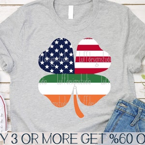 May include: A gray t-shirt with a four-leaf clover design. The clover is made up of the American flag, the Irish flag, and a green stem. The text "BUY 3 OR MORE GET %60 OFF" is at the bottom of the image.
