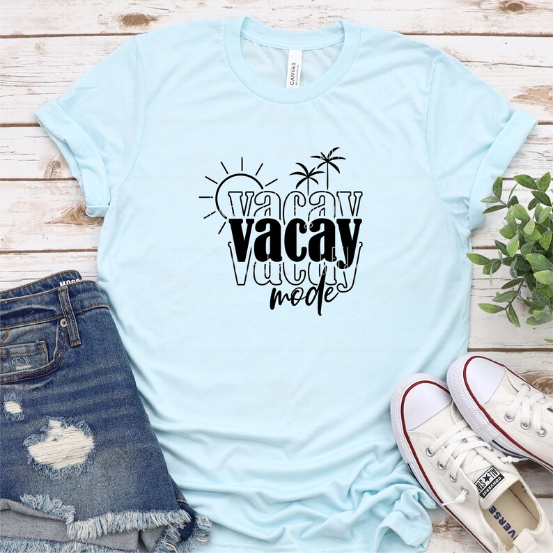 May include: A light blue t-shirt with a black graphic that says "vacay mode" with palm trees and a sun.