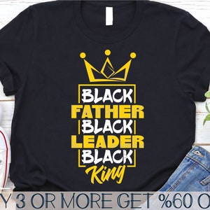 May include: Black t-shirt with a gold crown and the text "BLACK FATHER BLACK LEADER BLACK King".