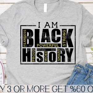 May include: A grey t-shirt with a black and yellow graphic that says "I AM BLACK HISTORY" with the words "FEARLESS, POWERFUL, PROUD, WOKE, SMART, STRONG" surrounding the main text.