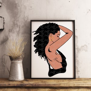 May include: Framed art print featuring a stylized illustration of a woman with black curly hair and a black dress. The artwork includes the word "Queen" and the artist's signature. The woman is wearing a gold hoop earring.
