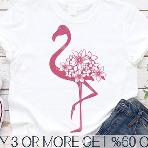 May include: A pink flamingo silhouette with white floral details on a white t-shirt. The text "BUY 3 OR MORE GET %60 OFF" is at the bottom of the image.