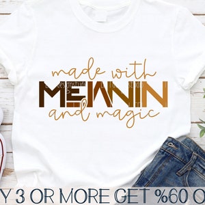 May include: White t-shirt with the text "made with MEANIN and magic" in brown letters. The letters are layered with different shades of brown.
