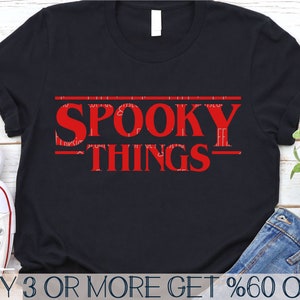 May include: Black t-shirt with red text that reads "SPOOKY THINGS" in a retro font style.