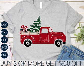 May include: Red pickup truck with a Christmas tree and presents in the bed. The truck is on a gray t-shirt with the text "BUY 3 OR MORE GET %60 OFF".