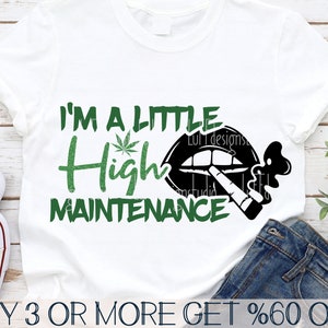 May include: White t-shirt featuring the text "I'M A LITTLE High MAINTENANCE" in green and black. The design includes a cannabis leaf and a graphic of lips with a lit cigarette. The shirt is paired with blue denim jeans.