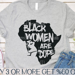 May include: A gray t-shirt with a black silhouette of the continent of Africa. The silhouette includes a woman's face and the text "BLACK WOMEN ARE DOPE".