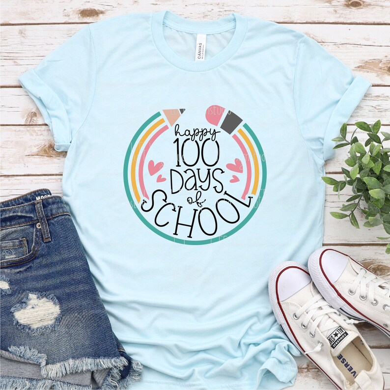 May include: A light blue t-shirt with a colorful rainbow circle design that says "happy 100 days of school".