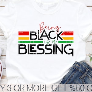 May include: A white t-shirt with the text "Being Black is a Blessing" in black letters with red, yellow, and green stripes behind the text. The text "BUY 3 OR MORE GET %60 OFF" is at the bottom of the image.