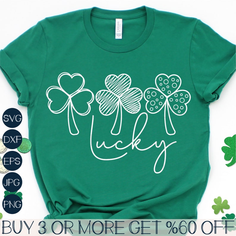 May include: A green t-shirt with a white design of three shamrocks and the word "lucky" written in a cursive font.