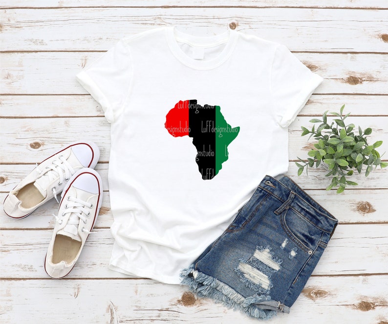 May include: White t-shirt with a black outline of the continent of Africa. The continent is filled with red, black, and green colors, representing the Pan-African flag.