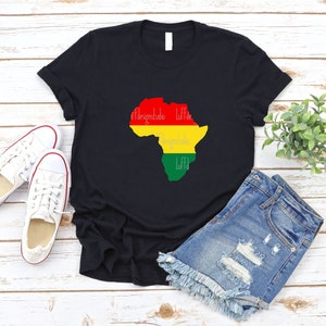 May include: Black t-shirt with a red, yellow, and green outline of the continent of Africa. The words "Designstudio Liff" are written in white inside the outline.