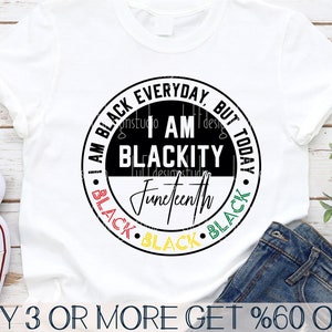 May include: A white t-shirt with a black and white circle design. The circle has the text "I am Black Everyday, But Today I am Blackity Juneteenth" in black and green text. The circle is surrounded by the word "Black" in red, yellow, and green text.