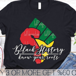 May include: Black t-shirt with a raised fist graphic in red, yellow, and green colors. The text "Black History know your roots" is printed in white below the graphic.