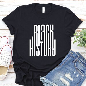 May include: Black t-shirt with the words "Black History" printed in white on the front.