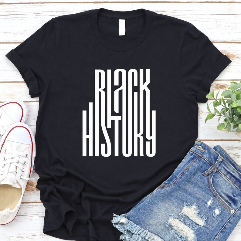 May include: Black t-shirt with the words "Black History" printed in white on the front.