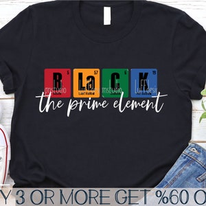 May include: Black t-shirt featuring a graphic design of the periodic table elements spelling out "Black" and the text "the prime element".