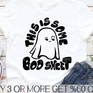 May include: A white t-shirt with a black graphic of a ghost with the text "This is some boo sheet".