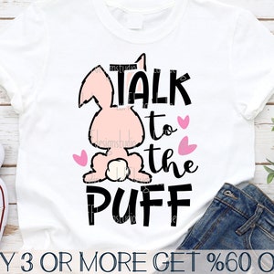 May include: A white t-shirt with a pink bunny rabbit and the text "TALK to the PUFF" in black. The bunny has pink hearts around it.