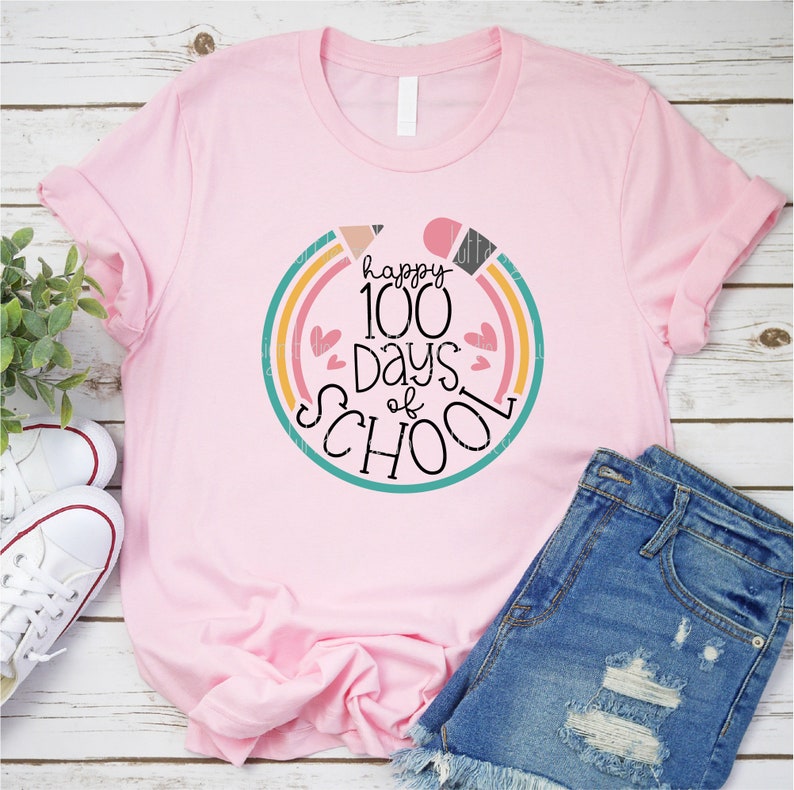 May include: Pink t-shirt with a colorful graphic that says "happy 100 days of school" with hearts and a rainbow design.