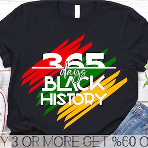 May include: A black t-shirt with a graphic design of red, yellow, and green stripes. The graphic includes the text "365 days Black History".