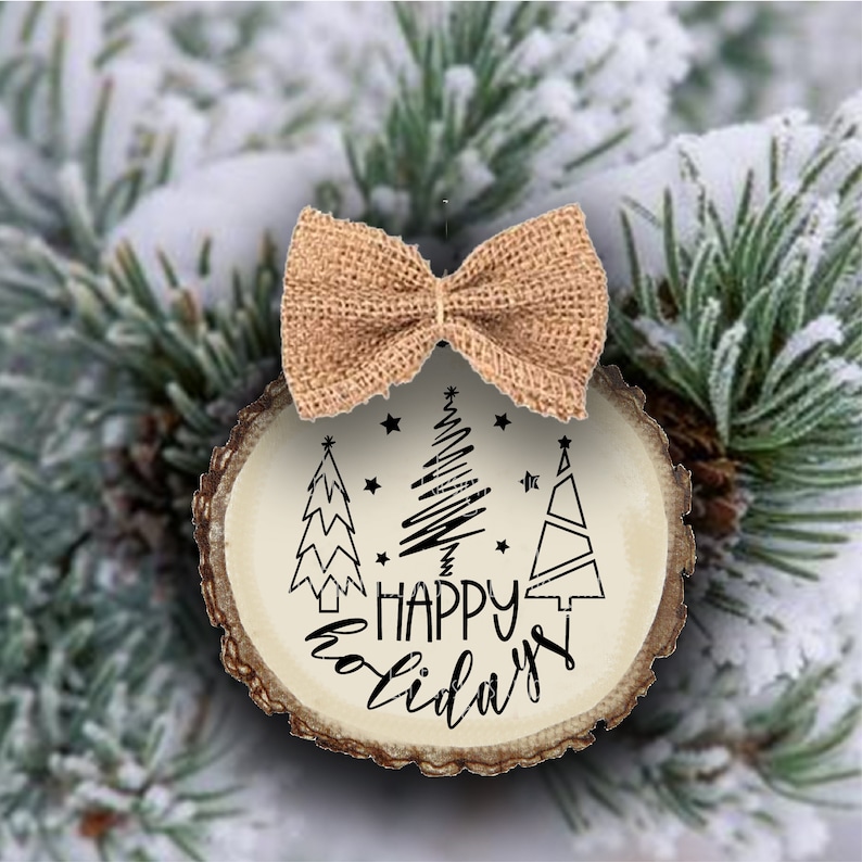 May include: A wooden Christmas bauble with a rustic brown finish. It features three stylised Christmas trees and the text "Happy Holidays". A burlap bow is tied around the top of the bauble.
