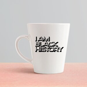 May include: White ceramic coffee mug with a black graphic that reads "I AM BLACK HISTORY".