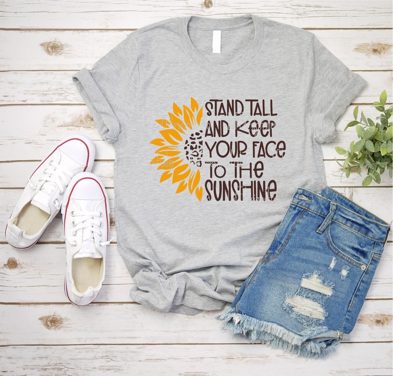 May include: Gray t-shirt with a sunflower graphic and the text "Stand Tall and Keep Your Face to the Sunshine".