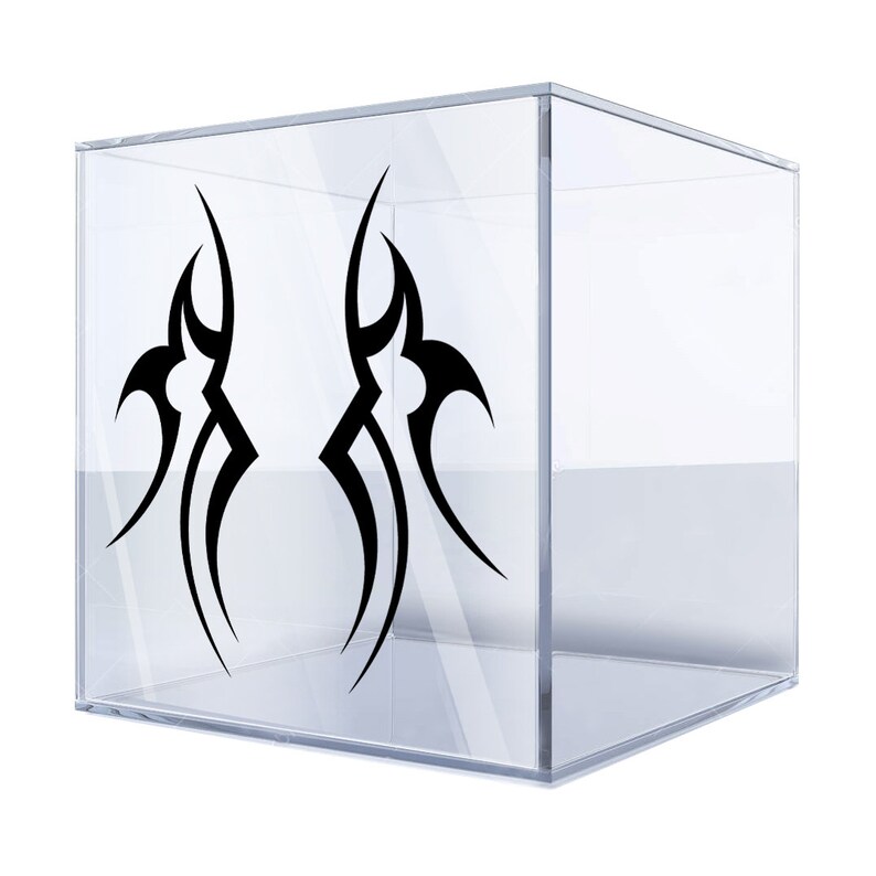 May include: A clear acrylic cube with a black tribal design sticker on each side. The design is a stylized flame shape.