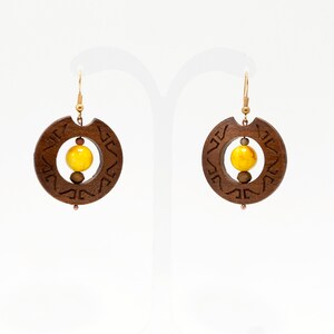 Ayame. Ιroko wooden earrings in circle shape with celtic engraved pattern and Yellow beads. A056-4