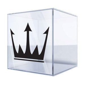 May include: A clear acrylic cube display box with a black crown sticker on the front.