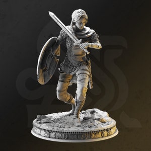 May include: A white painted miniature figurine of a female warrior holding a sword and shield. The figurine is standing on a detailed base with a textured surface.