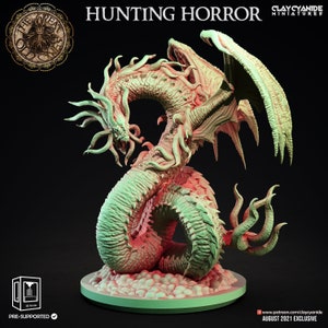 May include: A 3D printed miniature of a green and white hunting horror creature with wings and tentacles. The creature is posed in a coiled position with its head raised and mouth open. The miniature is pre-supported and is an August 2021 exclusive from Clay Cyanide Miniatures.