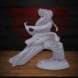 May include: A light gray unpainted miniature figurine of a warrior in a dynamic combat stance. The figure features a long braided beard, flowing robes, and segmented armor plates, holding a curved blade in a defensive position on a round base.