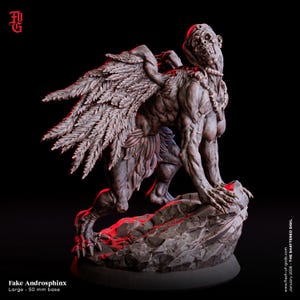 May include: A dark grey, detailed miniature figurine of a winged creature with a skeletal face, muscular humanoid torso, and clawed limbs, standing on a rocky base. The base is labeled as a 50 mm base, and the text reads Fake Androsphinx.