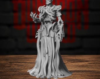 May include: A grey, unpainted miniature figurine of a skeletal humanoid figure with an exposed ribcage, wearing ornate shoulder armor and a long, flowing, pleated skirt. The figure stands in a pose with one hand extended forward, palm open.