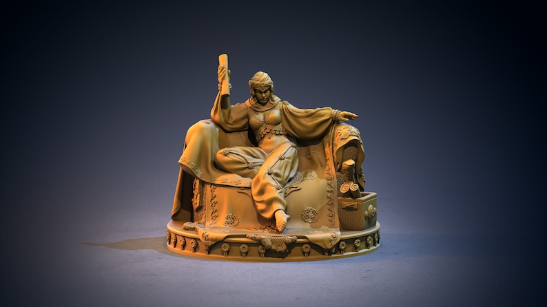 May include: A monochromatic tan resin figurine of a seated figure resting on an ornate, cushioned throne. The figure wears loose-fitting trousers and a top, holding a scroll in one hand. A small chest sits beside the throne on a circular base.