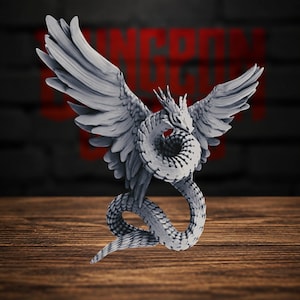 May include: A light gray miniature figurine of a winged serpent with a coiled body and feathered wings extended upward. The creature features a detailed scaled texture along its long, winding tail and a sharp, pointed head with crest-like spikes.