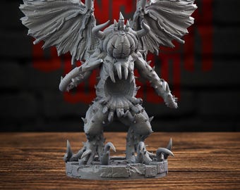 May include: A gray, unpainted miniature figurine of a winged creature with a pumpkin-shaped head, sharp horns, and a hollow, toothy torso. The figure stands on a circular, stone-textured base, featuring spiky limbs and large, textured wings.