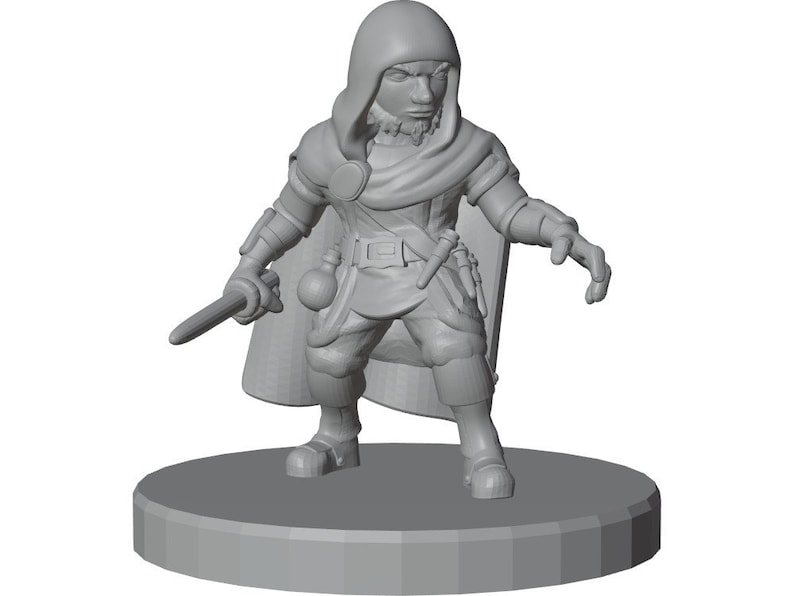 以下が含まれることがあります： フードを被ったキャラクターの未塗装の灰色のミニチュアフィギュア。円形の台座の上に立っています。マントを羽織り、ポーチと小さな短剣が付いたベルトを締め、右手に短い剣を持ち、左手を前に突き出しています。