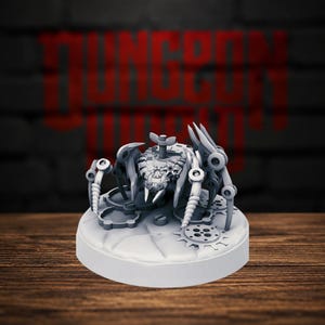 Peut inclure: Une figurine miniature grise non peinte représentant une araignée mécanique avec de multiples pattes articulées, une protubérance centrale en forme de vis sur le dos et des détails en forme d'engrenages sur sa base circulaire.