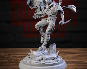 May include: A gray unpainted resin miniature figure of an elf-like character with pointed ears, wearing a scarf, tunic, and armor, holding a small dagger. A hawk is perched on the character's outstretched arm, all standing on a rocky base.