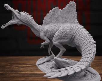 Puede incluir: Una figura de dinosaurio Spinosaurus gris sin pintar sobre una base ovalada. El modelo presenta una vela dorsal prominente, un hocico largo con dientes afilados y una piel texturizada y escamosa. La criatura tiene la boca abierta.